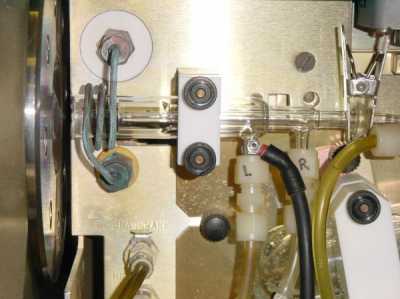 The three nested glass tubes that contain the
  plasma in the ICP-MS.  The vaporised sample passes from the
  right side through the plasma and into the mass spectrometer
  on the left.