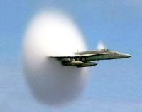 When a source, this time something like a
  fighter jet,
travels at a speed greater than the speed of sound, it actually
outruns the sound waves, and is said to break the sound barrier, and
arrives before the sound does.